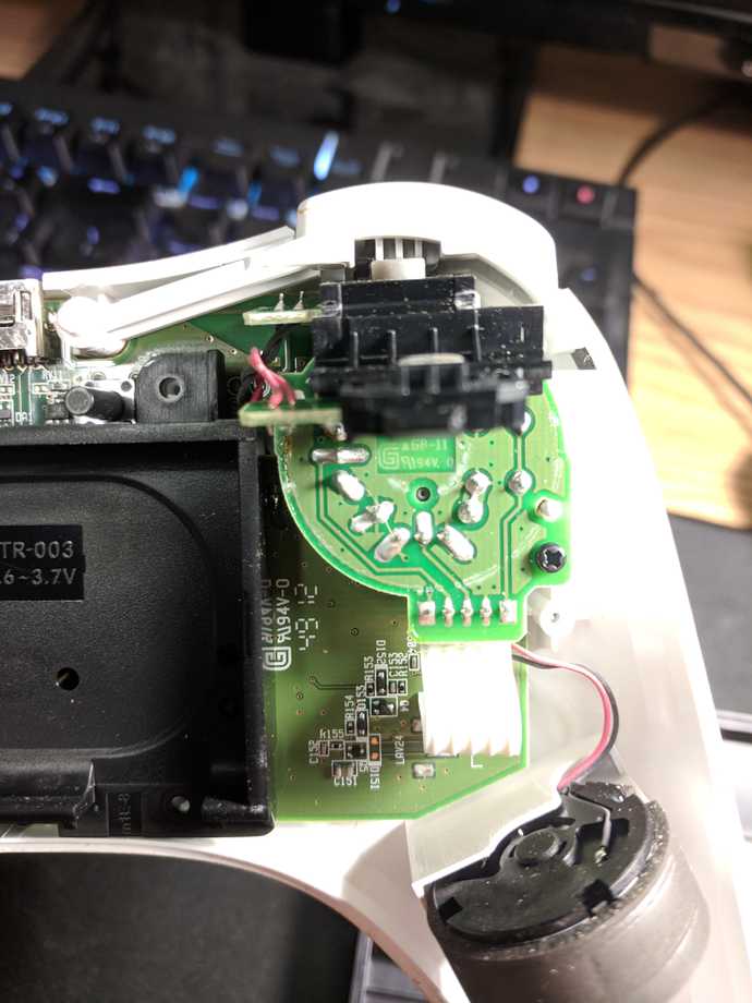 The ZL/L mini-board attached to the main board, and the rumble motor in the left side grip